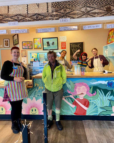 Employees and volunteers cheering inside the eatery